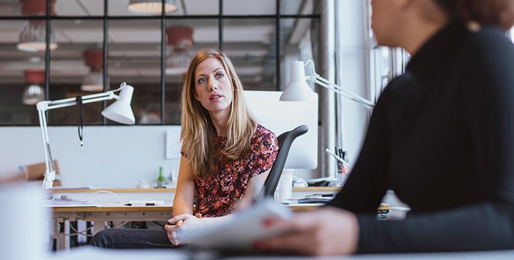 image of two women talking to each other in an office