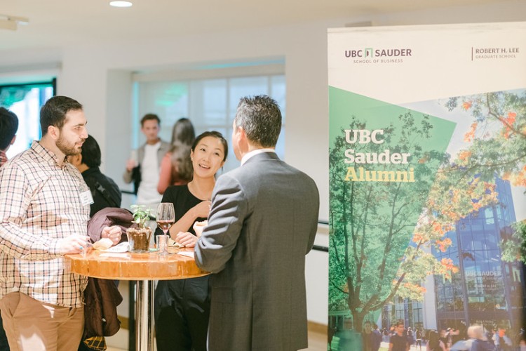 A group of UBC Sauder alumni networking at an event