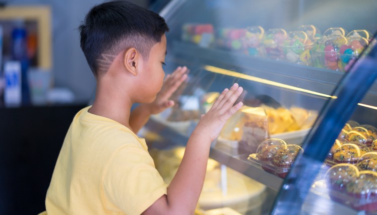 Child looking at baked goods.