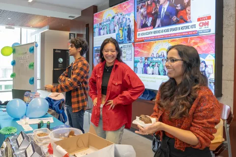 UBC Sauder students Arav Bubna (left), Alex Delcorro (center), and Abeer Amir (right) volunteering at the UBC Sauder Gives back midweek celebration bake sale